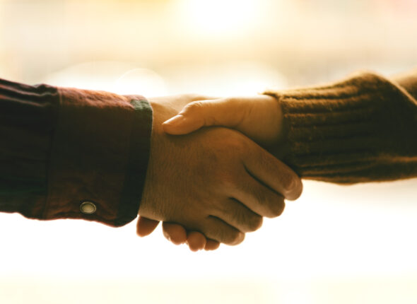 Closeup image of two people shaking hands